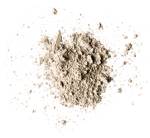 A pile of light brown powder scattered on a white background.