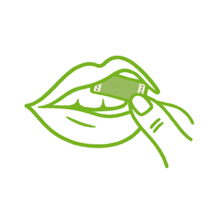 A green line drawing of a finger placing a small strip on a tongue in an open mouth.